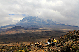 The guides have lunch nearby with Kibo Peak looming in the background