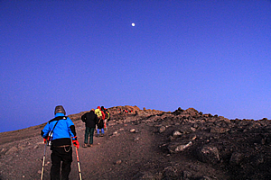 The moon shines bright over the summit