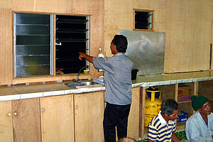 Sapinggi getting another bottle of rice wine through the window