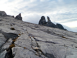 Crags rising from the grey dome